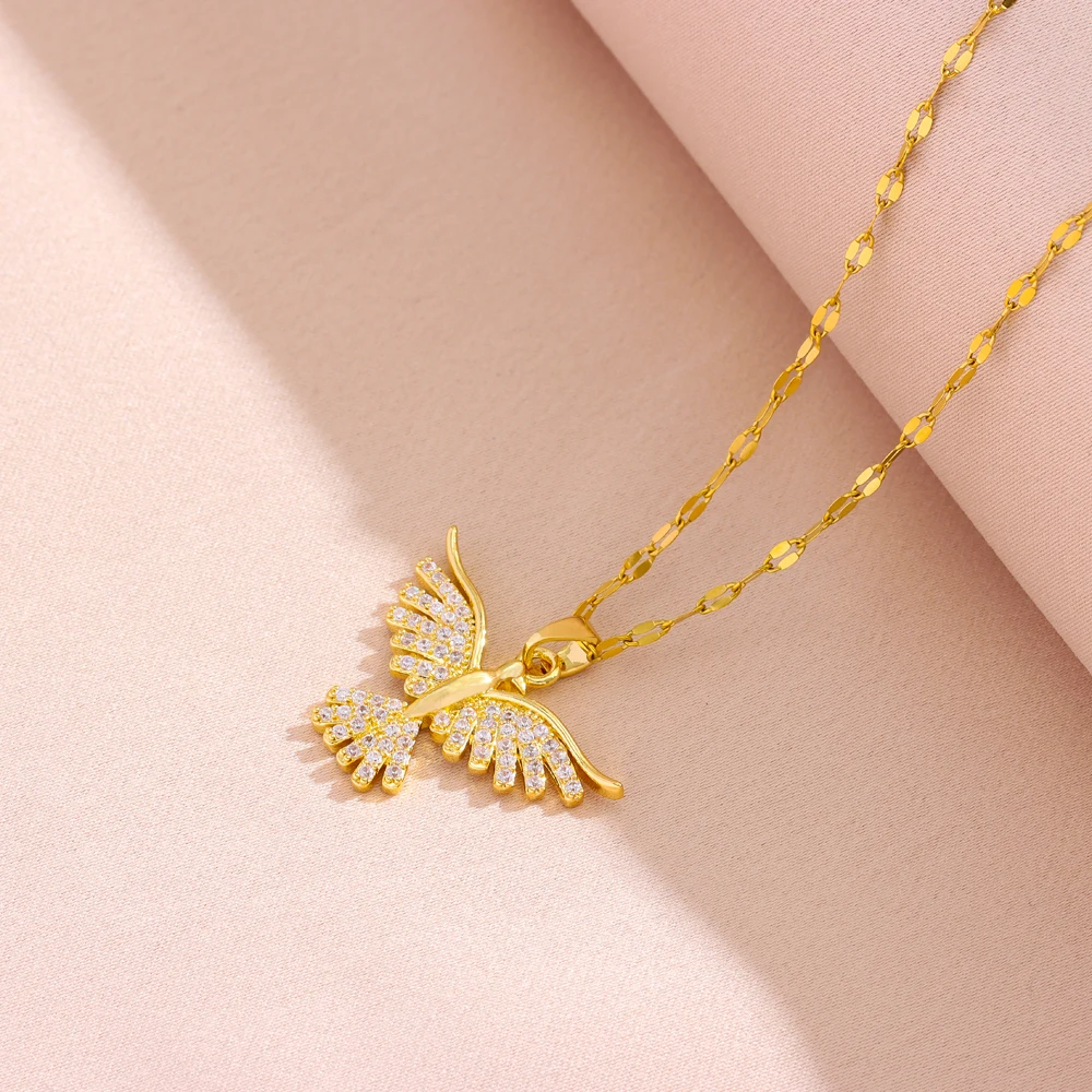 Vue rapprochée du pendentif oiseau : plumes gravées et rangs de zircons blancs sertis grain.